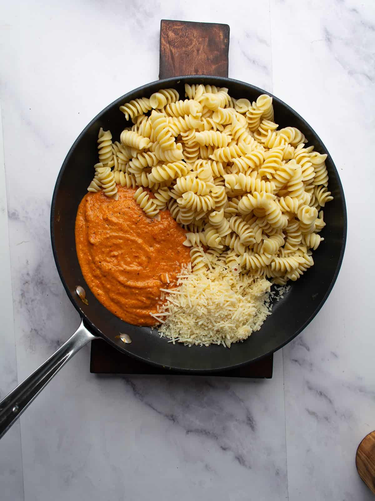 parmesan cheese, sauce, and the pasta is tossed for making red pepper pasta