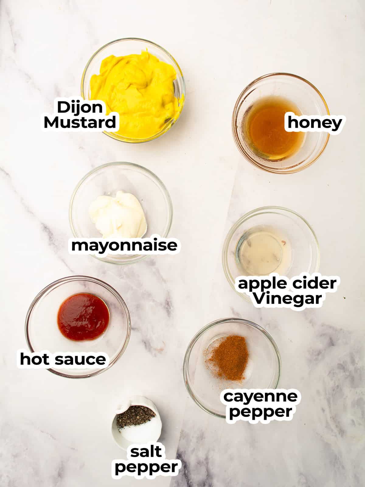 Ingredients for spicy honey mustard sauce arranged on a table.
