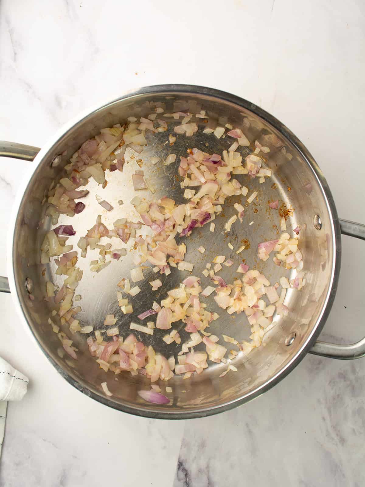 Onion and garlic sautéing in olive oil in a pot