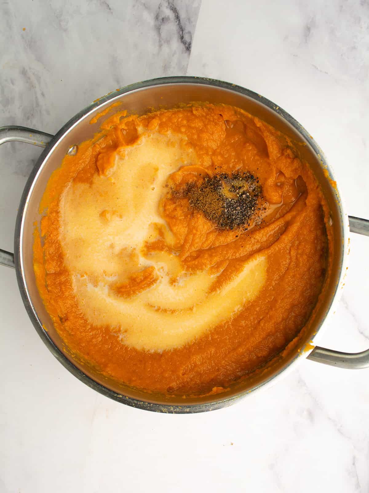 coconut milk, ground cumin, and ginger added to the soup