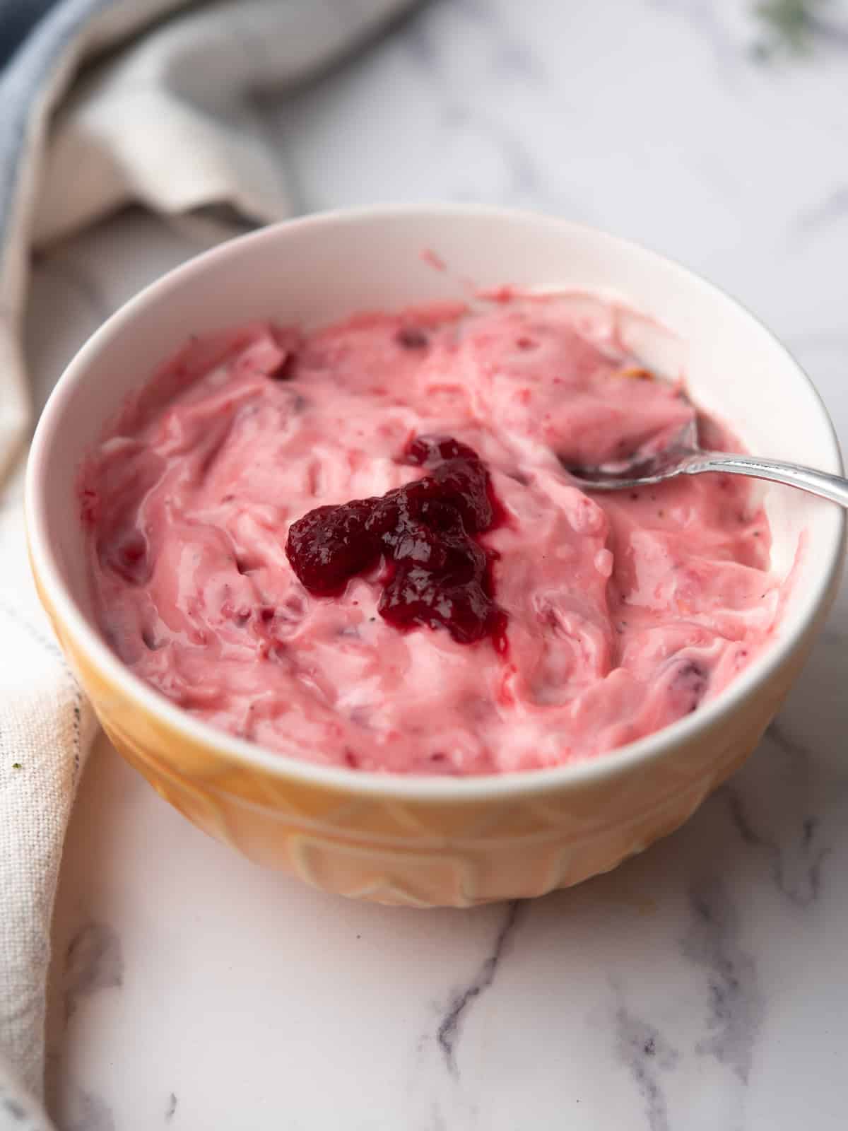 cranberry aioli garnished with cranberry sauce in a bowl