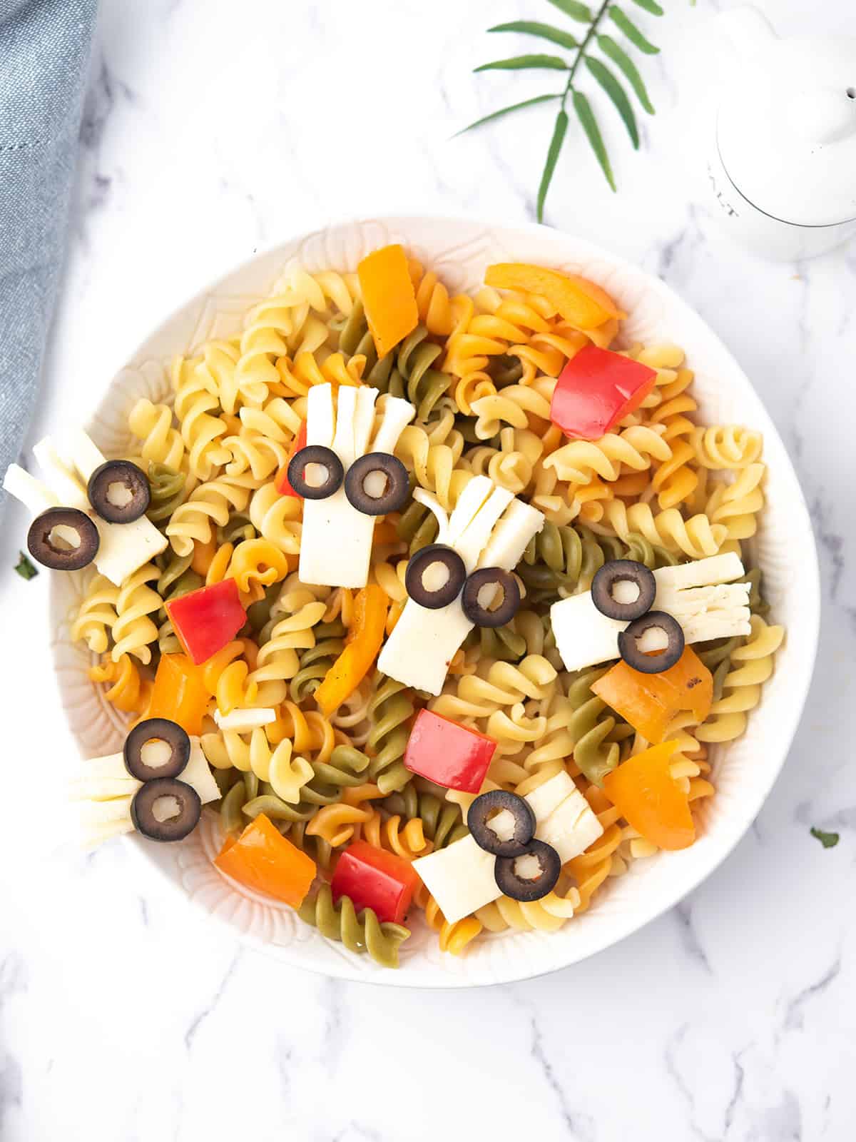 Colorful Halloween Pasta Salad with monster eyeballs and veggies.