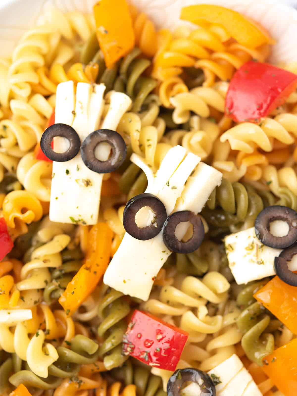 Zoomed-in view of Halloween Pasta Salad decorated with cheese eyeballs.
