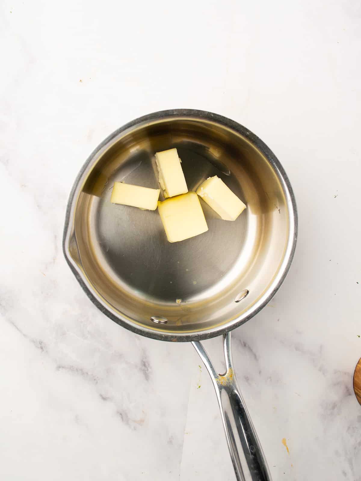 Melting butter and olive oil in a small saucepan over low heat.