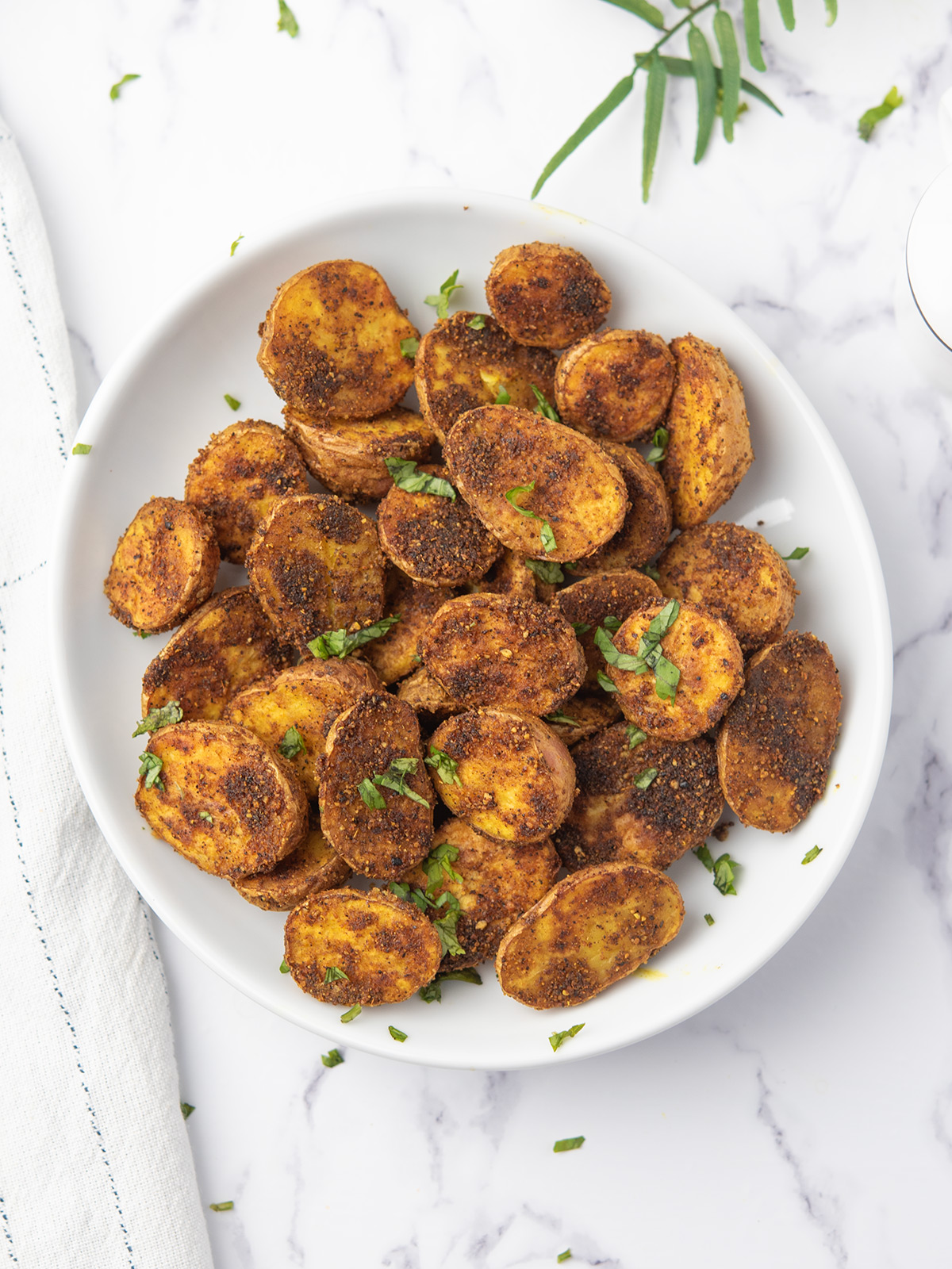 Delicious spicy roasted potatoes garnished with fresh cilantro.
