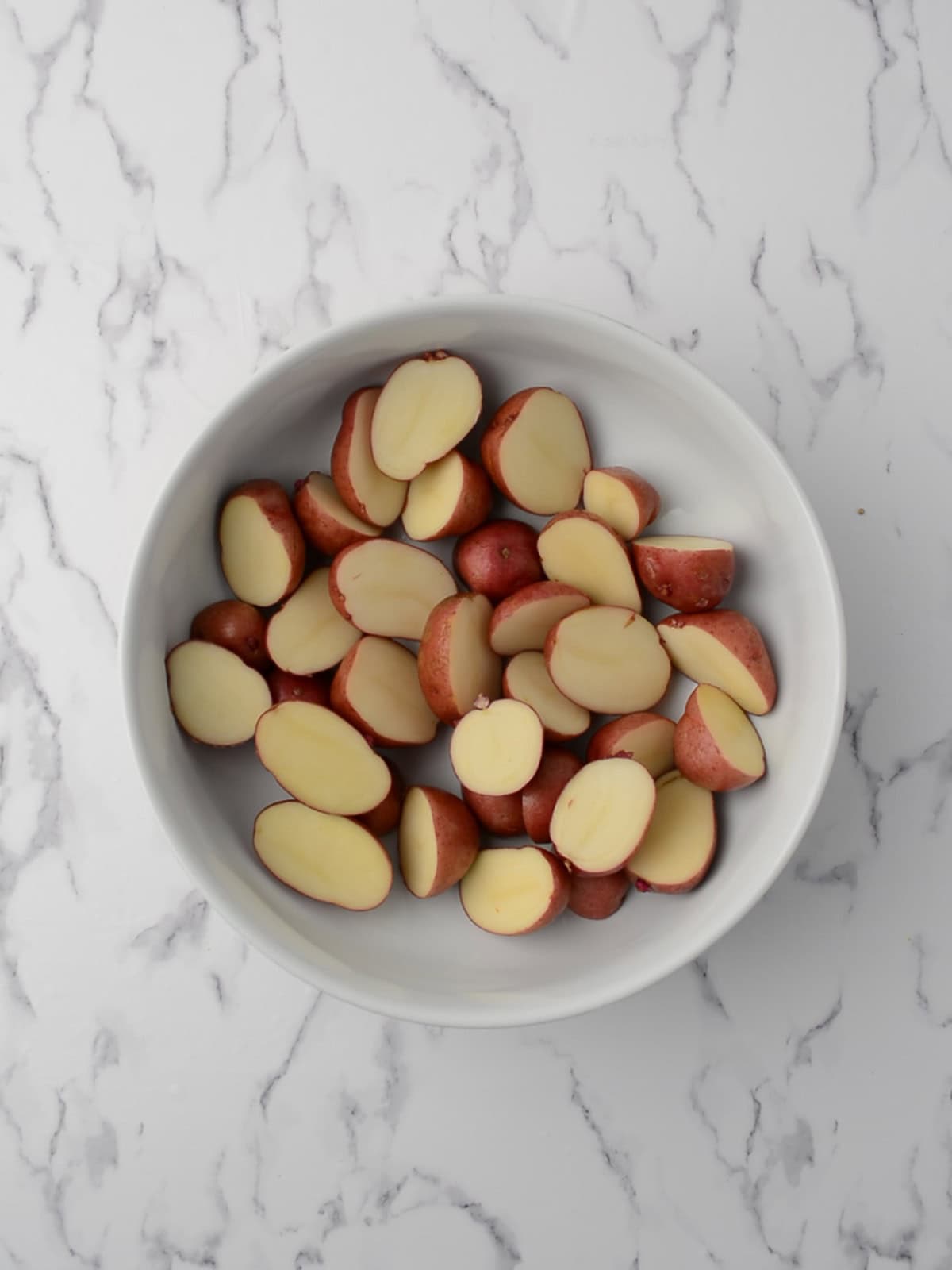 Parboiled potato chunks ready for roasting.