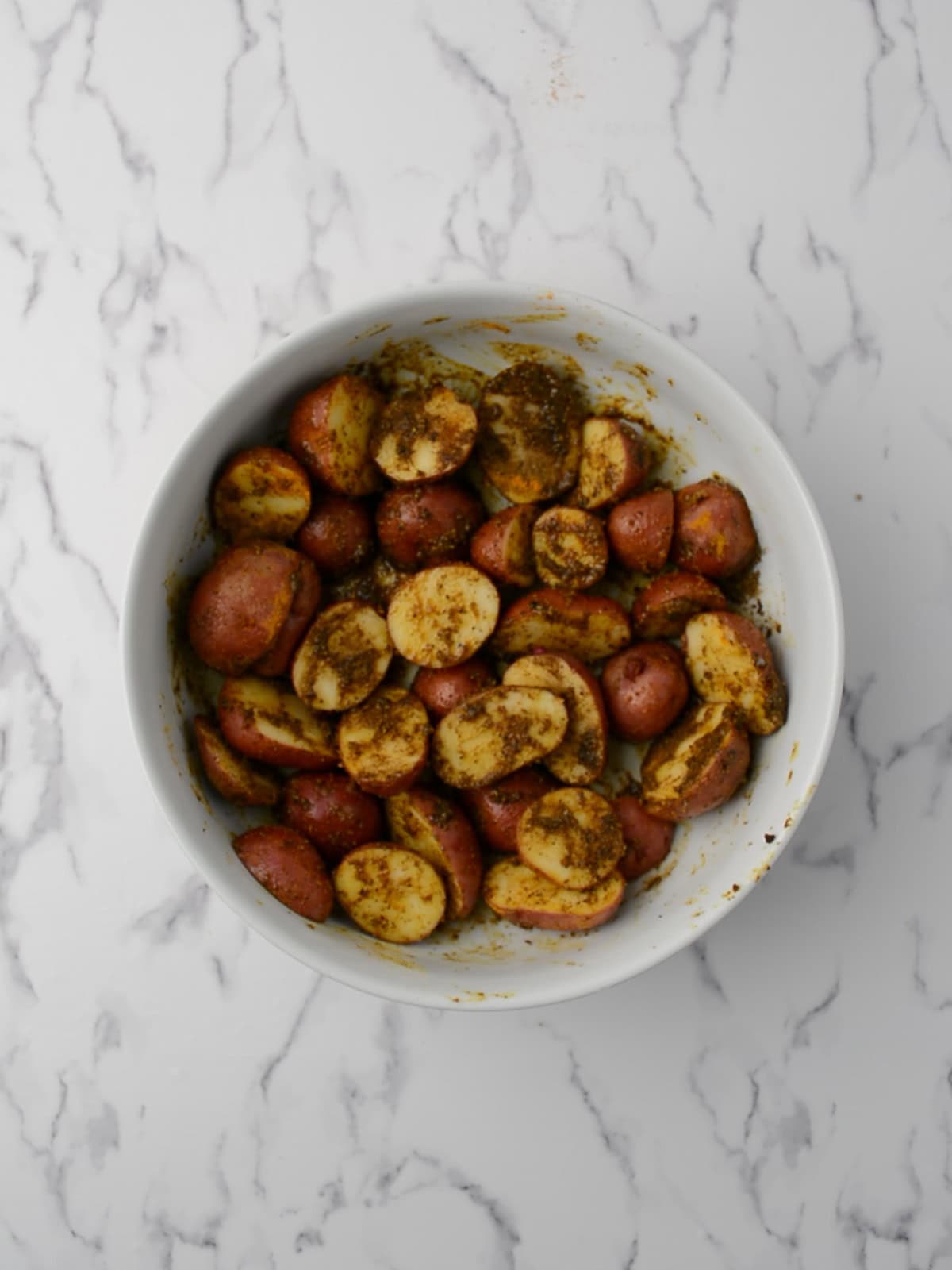spices mixed up to the potatoes