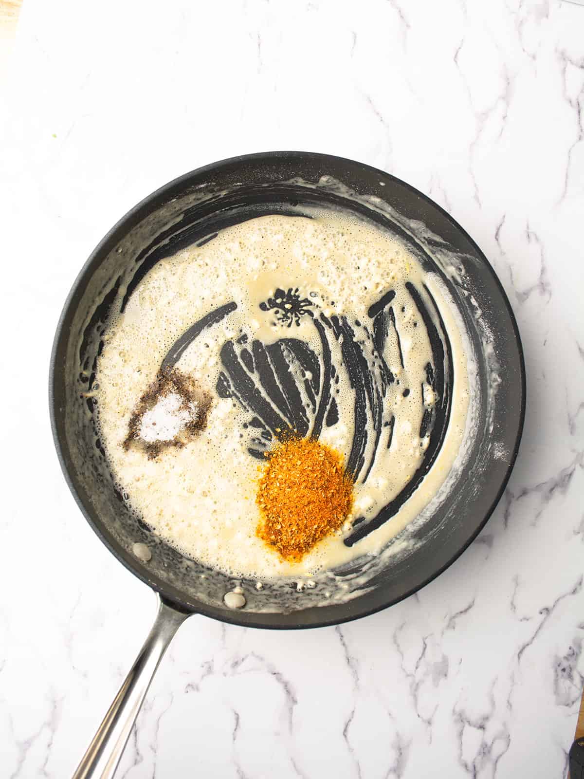 cajun seasoning added to the pan