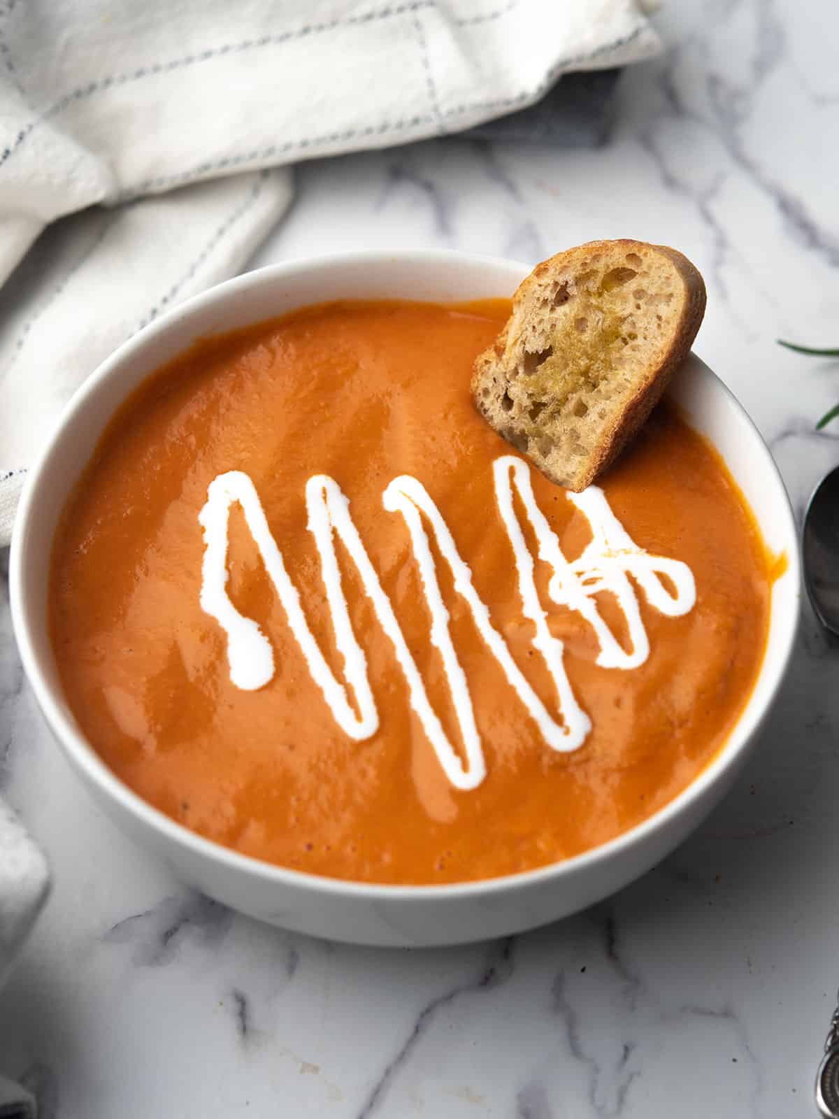 tomato soup with canned tomatoes garnished with cream and croutons