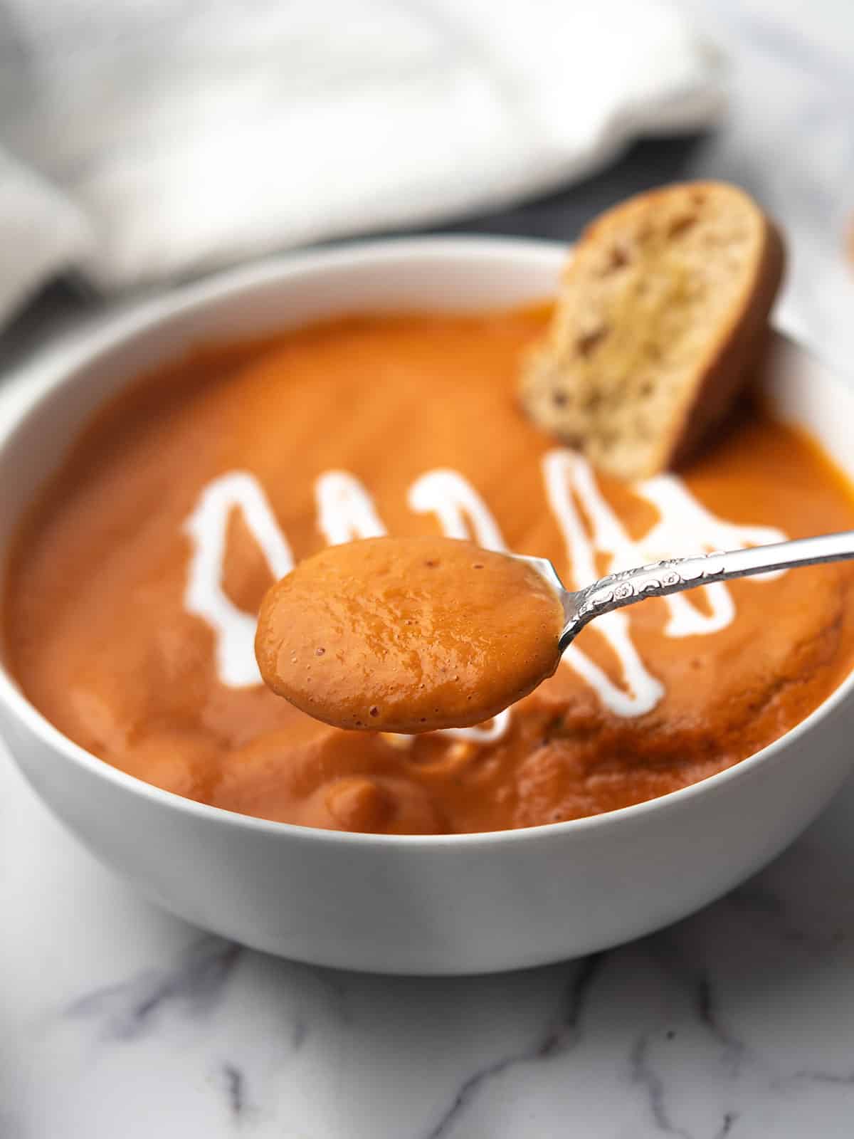 a spoonful of tomato soup with canned tomatoes ready to enjoy