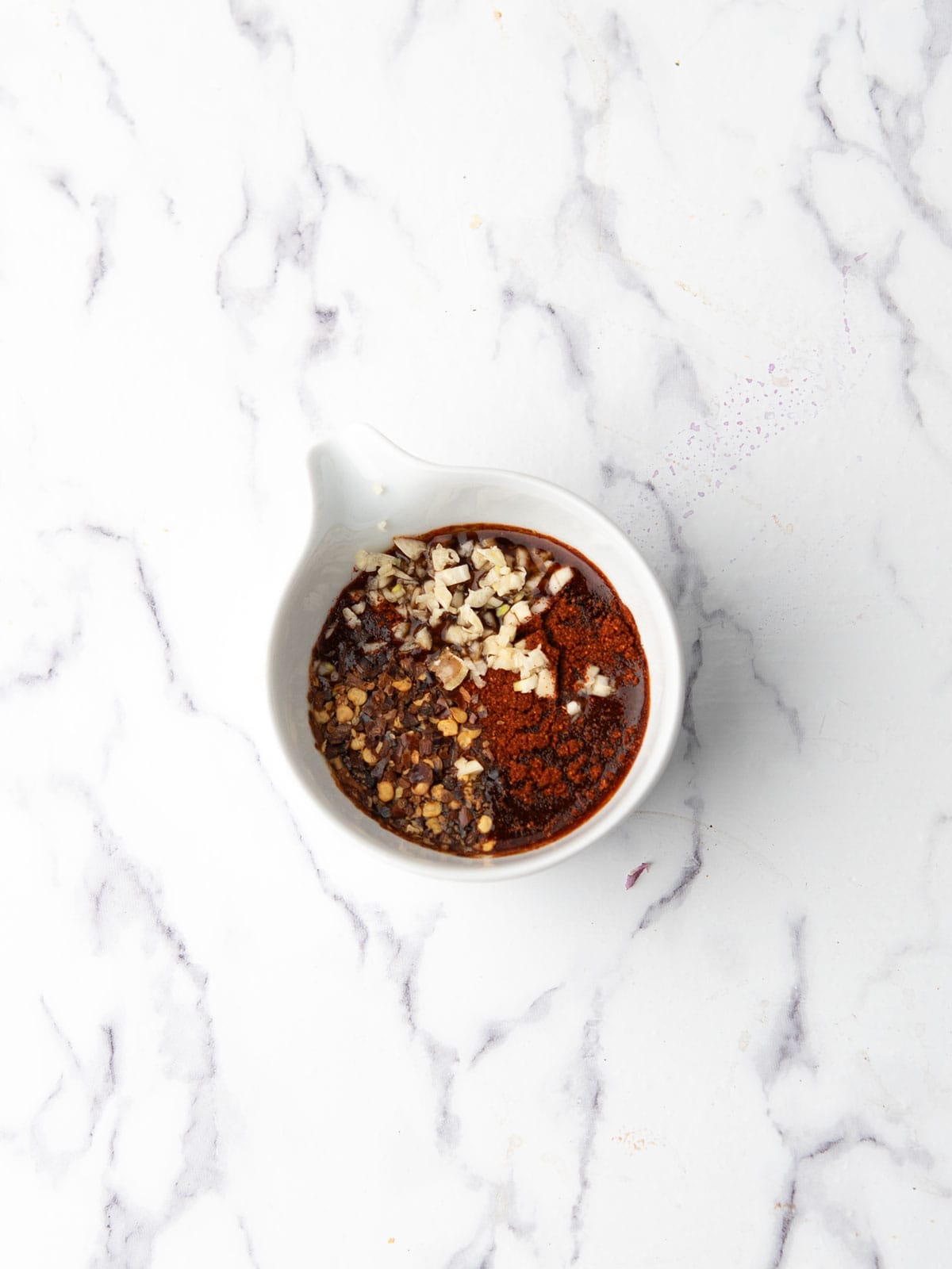 the ingredients for the sauce are added to a small mixing bowl.