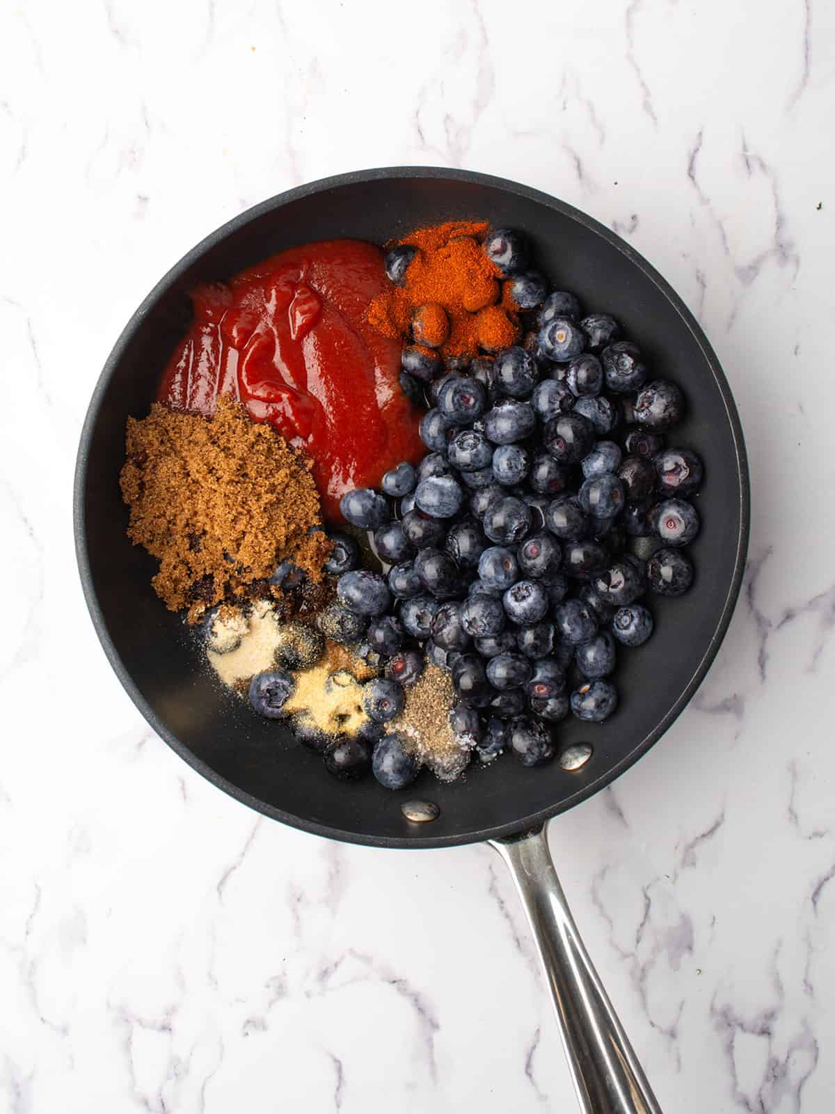 all the ingredients added to the pan including the blueberries.