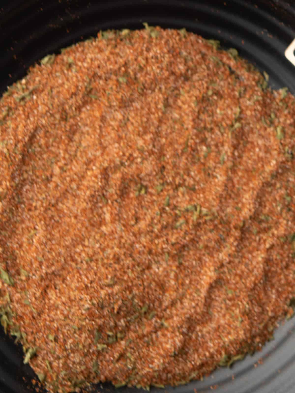 Mixing Cajun spices in a small bowl