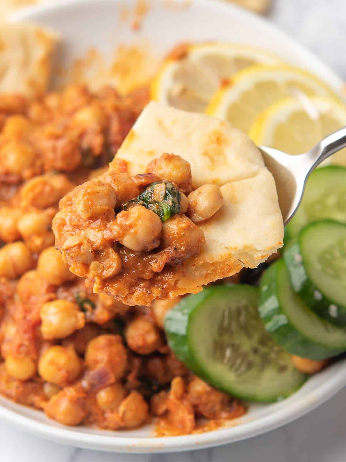 harissa chickpeas scooped in naan bread