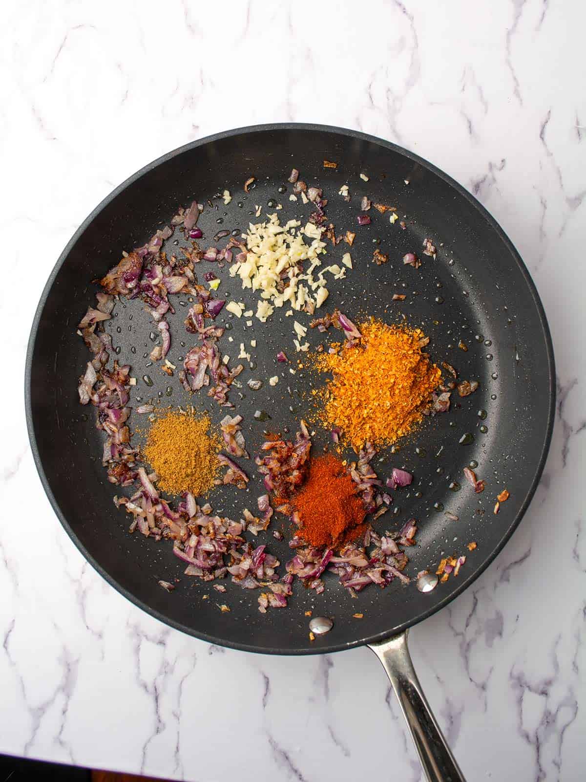 harissa seasoning, cumin powder, paprika added to the pan.