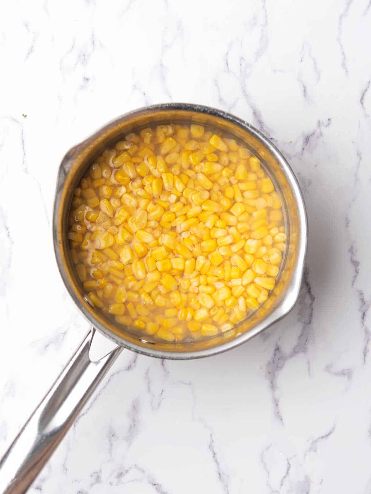 cooked corn kernals in a pan.