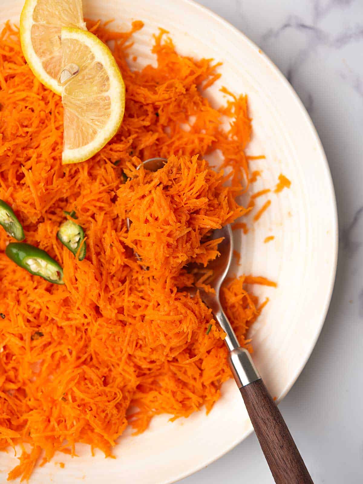 grated indian carrot salad with the spoon.