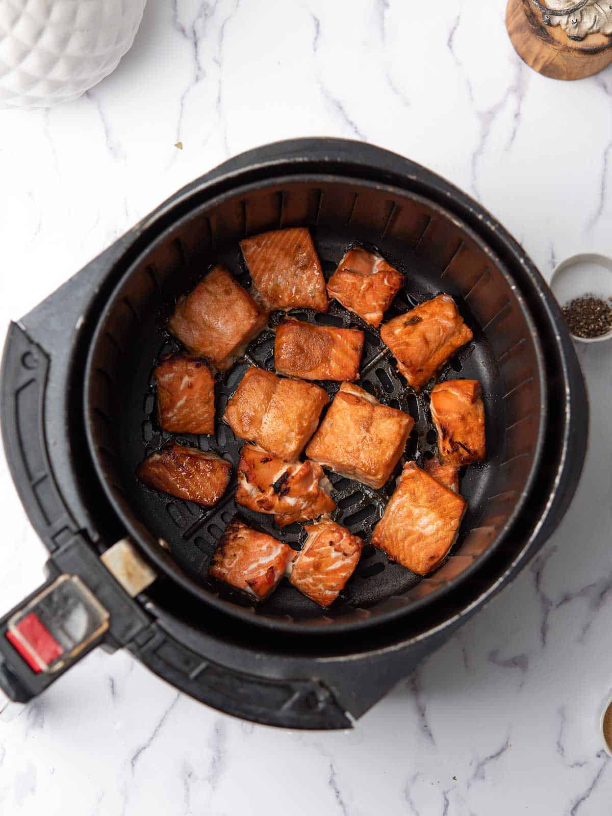 salmon cooked to flaky in the air fryer basket.