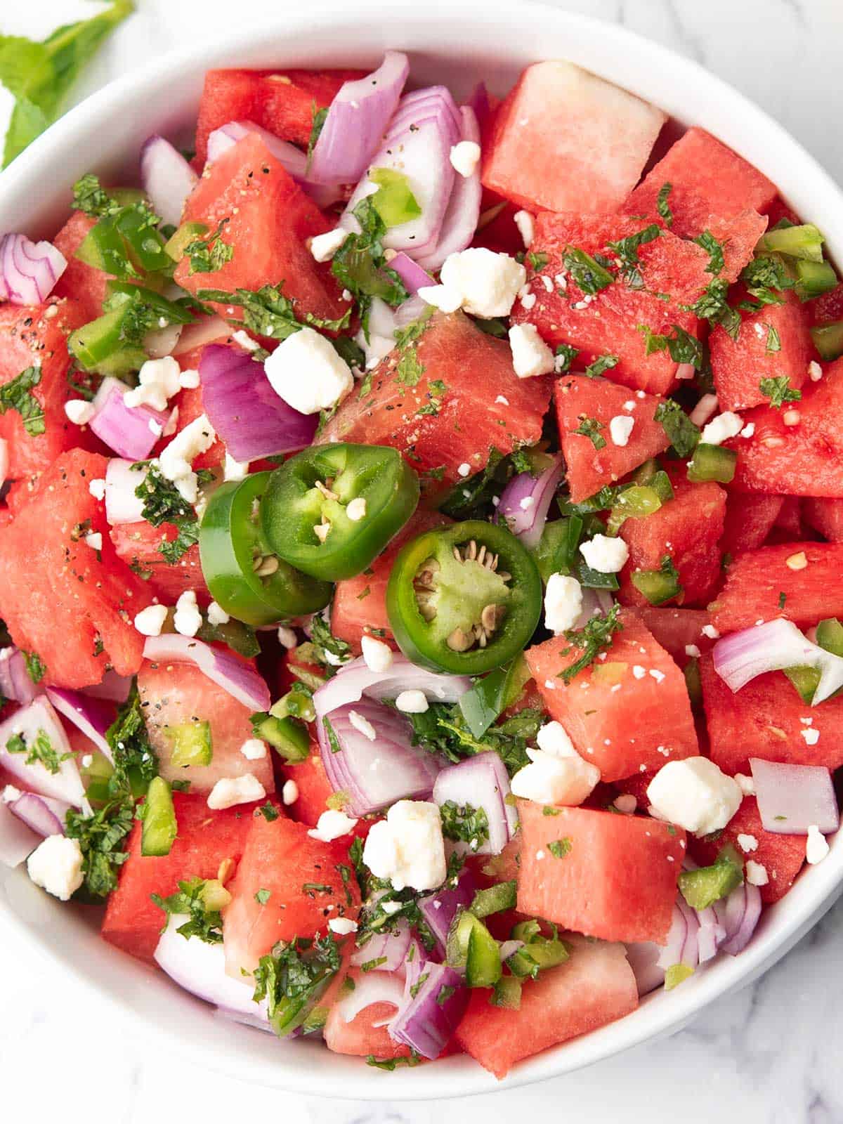feta and fresh mint sprinkled over the watermelon jalapeno salad.
