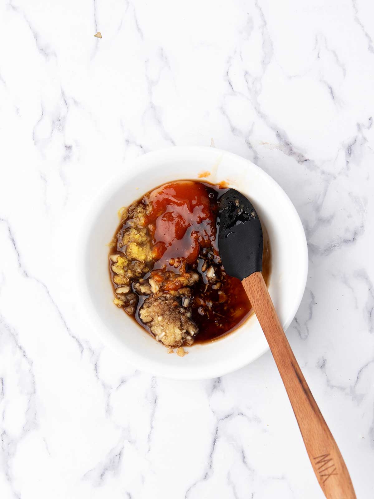 the ingredients are added to a mixing bowl for making the firecracker sauce.