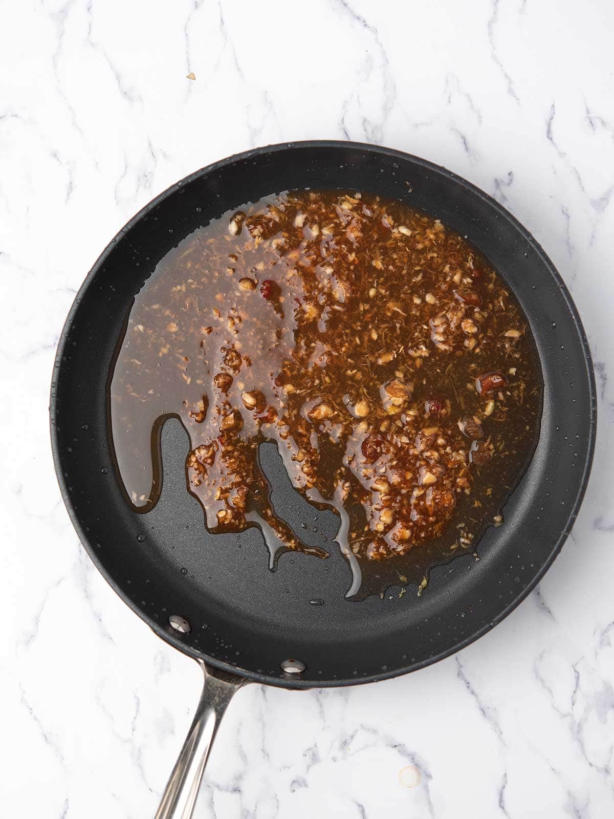 stirring the firecracker sauce in a pan over medium heat.