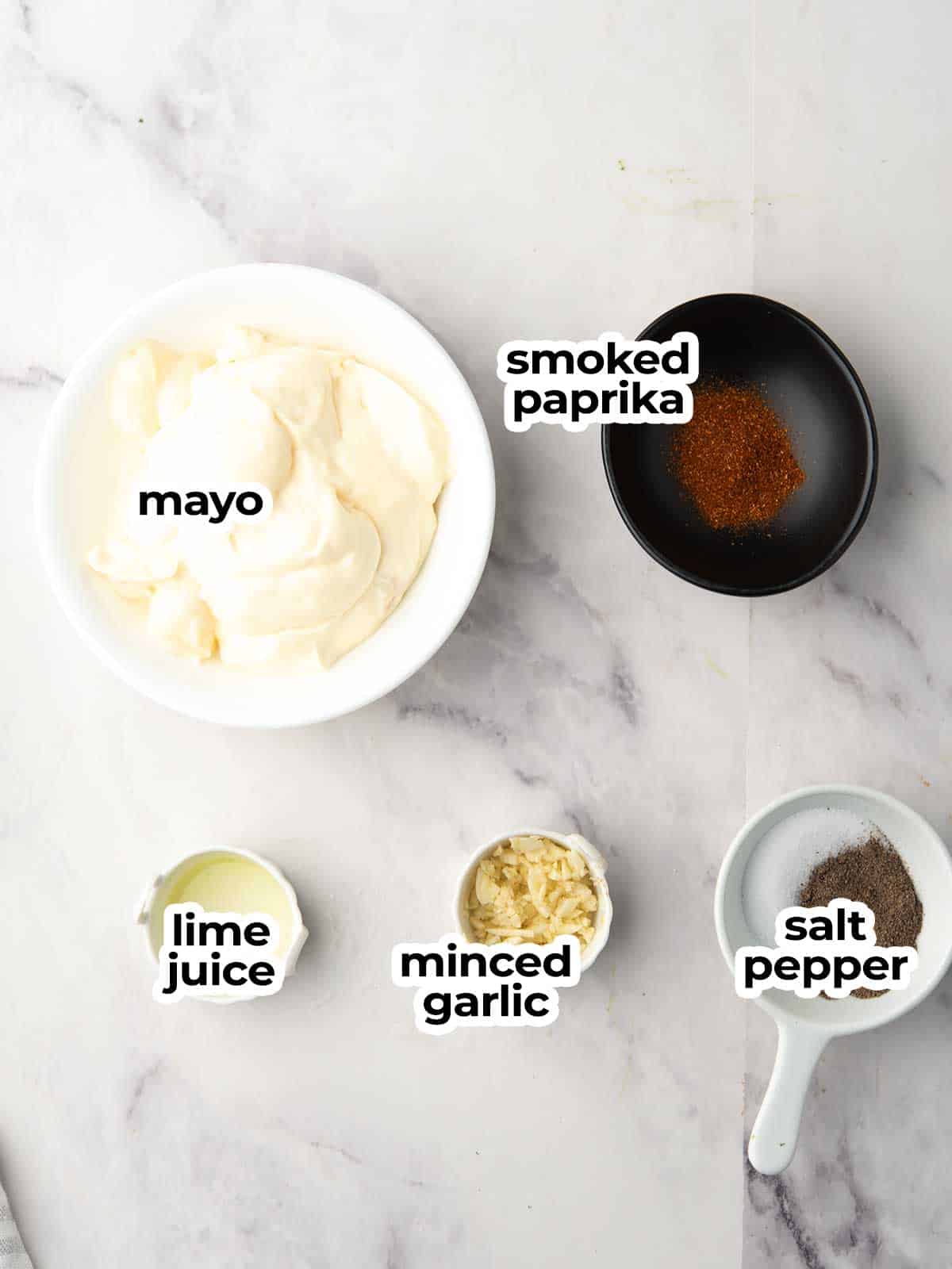 smoked paprika aioli ingredients are placed in the marble kitchen counter top.