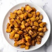 Sautéed sweet potatoes with browned edges, coated with smoked paprika, ready to serve as the side dish.