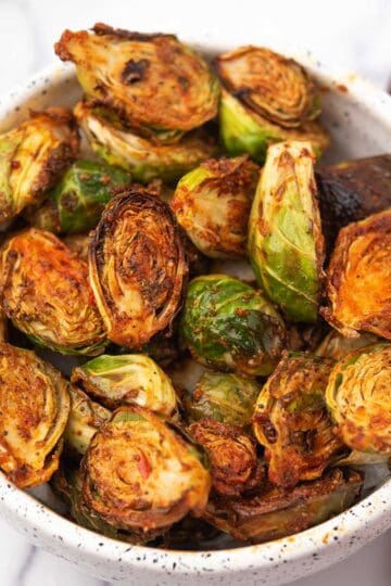 Crispy curry-spiced Indian Brussels sprouts served in a white bowl.